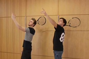 Two StepUP students pretending to hit a tennis ball.