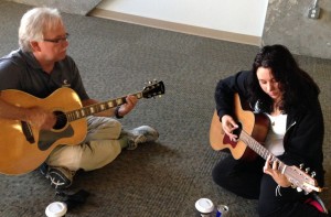 Councilor, Scott W., playing guitar with a StepUP student.