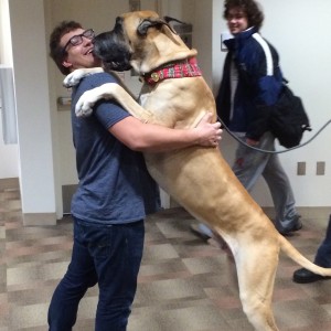 Blake H. hugging a dog as big as him.