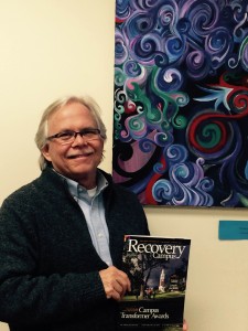 Photo of Scott W. holding a Recovery Campus magazine.