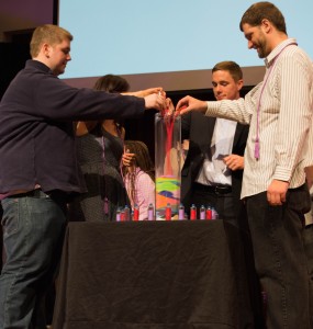 Photo of StepUP students pouring sand into a vase.
