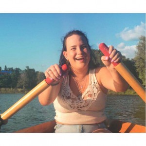 Izzie S. rowing on a river.
