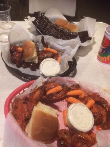 Photo of chicken wings and bread rolls.