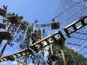 Two people climbing on the ropes course