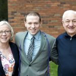 Photo of Ian C. with his parents.